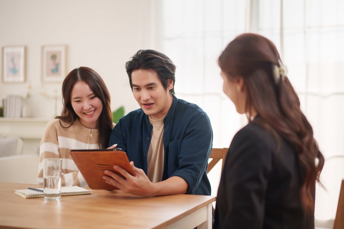 A couple consulting with an advisor about their financial strategy