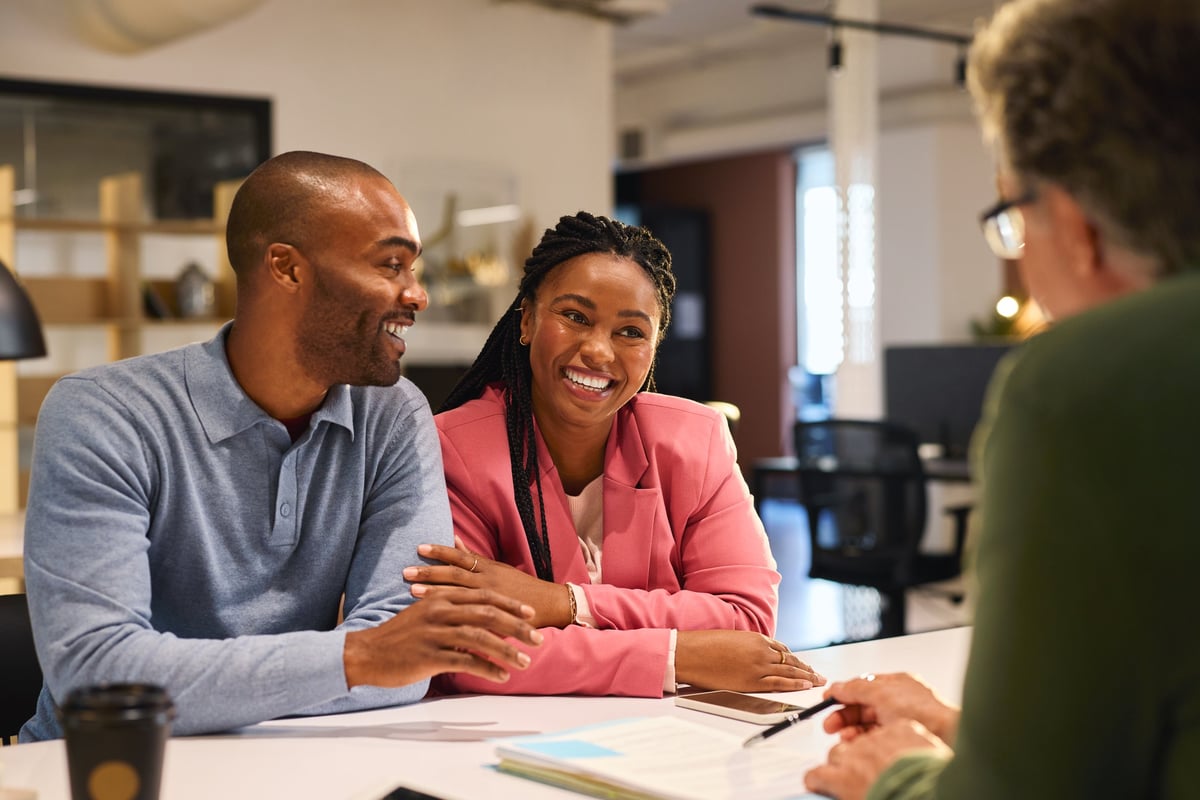 A couple meeting with their financial advisor to discuss their family's future